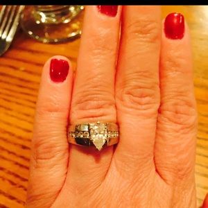 Crafted heavy 14k white gold and features a sparkling pair shape diamond